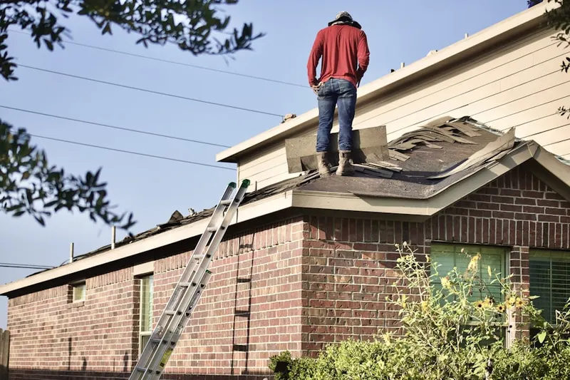 Professional roofer working on a residential roof in East Colton Heights